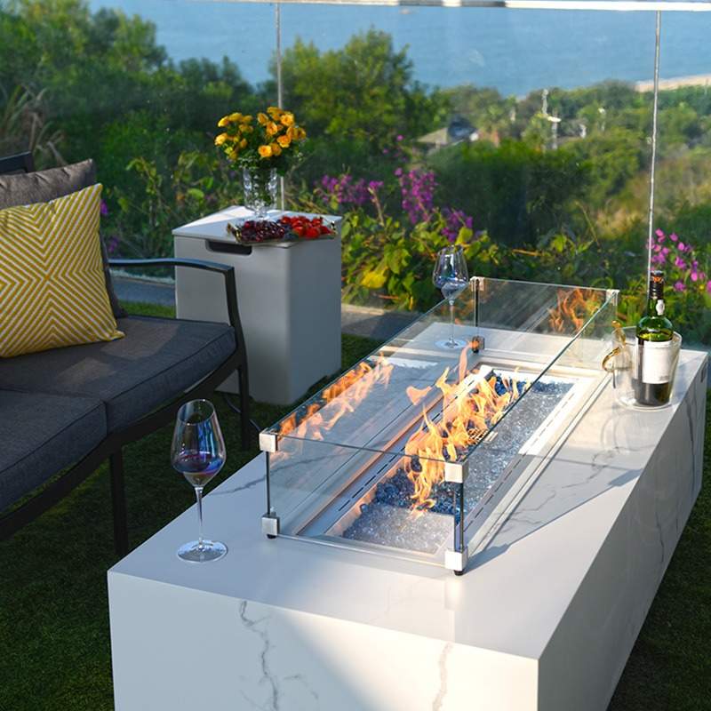 Carrara & Varna Fire Table in white enjoyed with wine