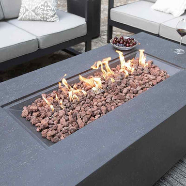 Elementi Andes Fire Pit in Dark Grey Variant showing its glowing flames placed in the outdoor patio
