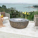 Elementi Boulder is placed in the outdoor patio as a table with its optional stainless steel lid