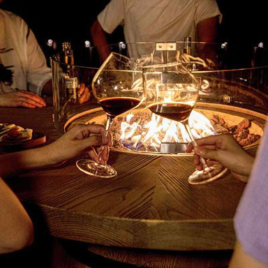Elementi Lafite Barrel Bar Table showing flame is being use by the people