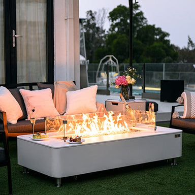 Glowing flames on the Athens Porcelain Fire Table by Elementi Plus placed on the outdoor patio