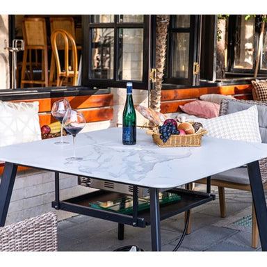 Helsinki Marble Porcelain Dining Table by Elementi Plus in white functioning as a full table placed outdoors