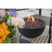 Jefferson Round Concrete Fire Bowl by Modeno in black placed outdoors to provide heat