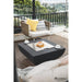 Modeno Aurora Fire Pit in Black double as a table and placed outdoors