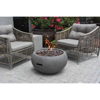 Newbridge Fire Bowl in Gray placed outdoors with a matching couches around
