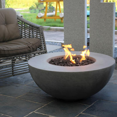 Roca Round Fire Pit by Modeno in Light Grey placed on the outdoor patio