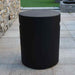 Round Tank Cover Smooth Finish by Elementi in Slate Black placed outdoors