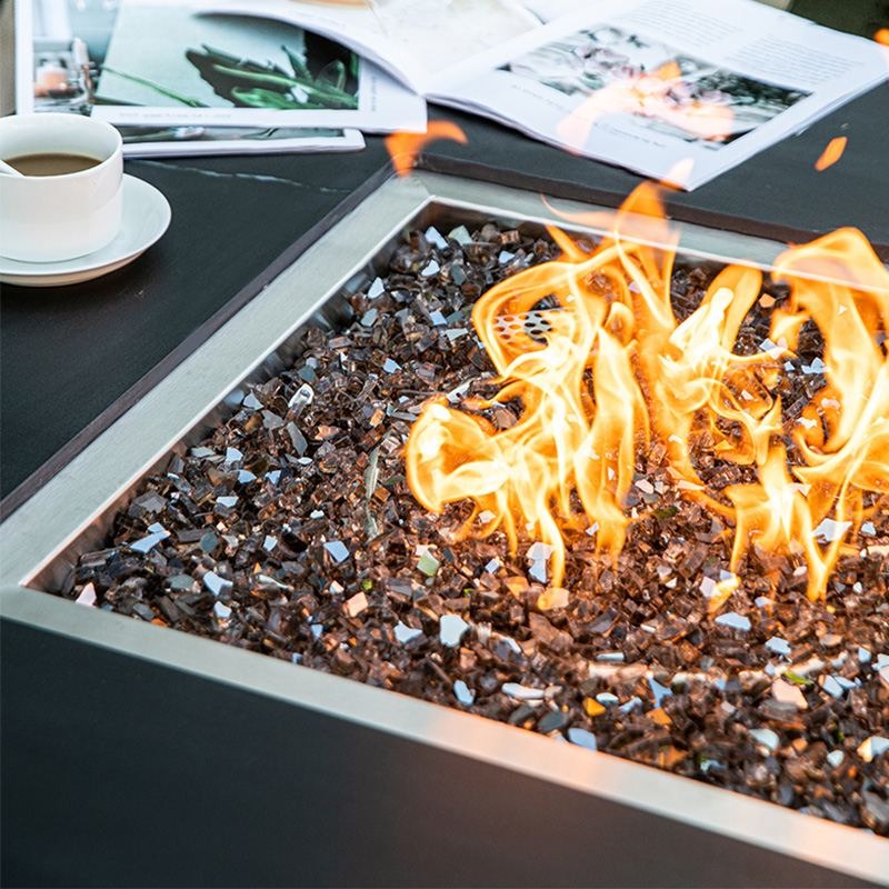 Showcasing the flames and fireglass of the Biano & Sofia Porcelain Fire Table