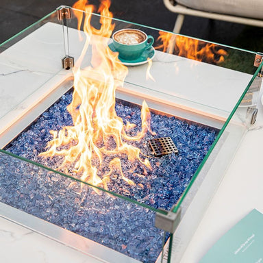 Showing the flames and fire glass of the white Biano & Sofia Porcelain Fire Table