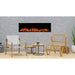 SimpliFire Forum Outdoor Electric Fireplace placed in an outdoor patio with wooden chairs