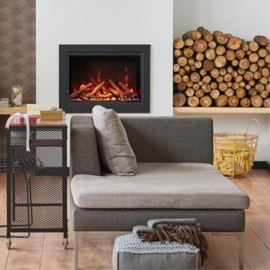 The Amantii Traditional is Placed In The Living Room With Real Logs Beside It