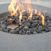 The Boulder Fire Table by Elementi is showing its flames and lava rocks