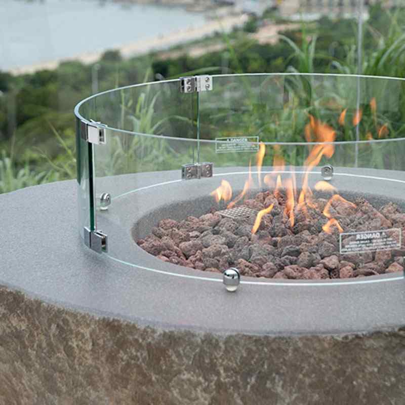 The Boulder by Elementi showcasing its flames and lava rocks outdoor with the optional windscreen