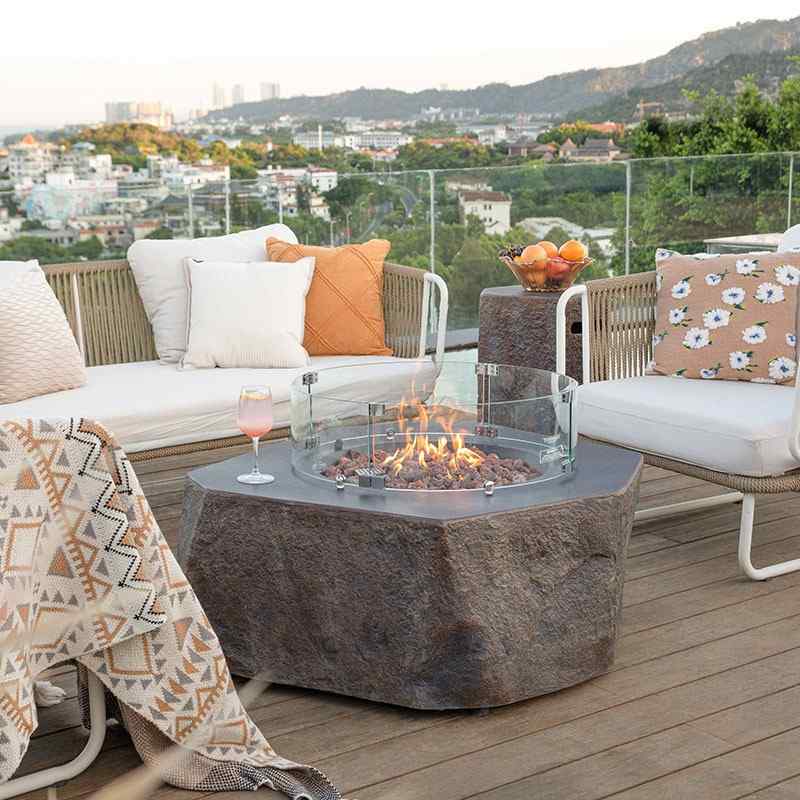 The Columbia Fire Table by Elementi Neutral placed in the outdoor terace to provide heat