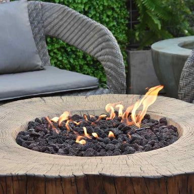 The Elementi Manchester Fire Table showcasing its flames and lava rock on the daylight