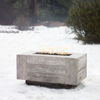 The Outdoor Plus Catalina Rectangular Concrete Fire Pit in the Cold Snow