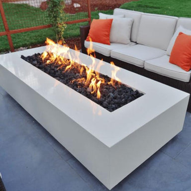 The Outdoor Plus Coronado Steel Fire Pit in White with Flames on the lava rocks