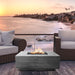 The Prism Hardscapes Tavola 3 Square Concrete Fire Pit by the beach