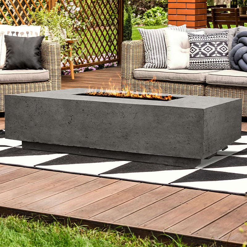 The Prism Hardscapes Tavola 4 Rectangular Concrete Fire Pit installed outside the patio