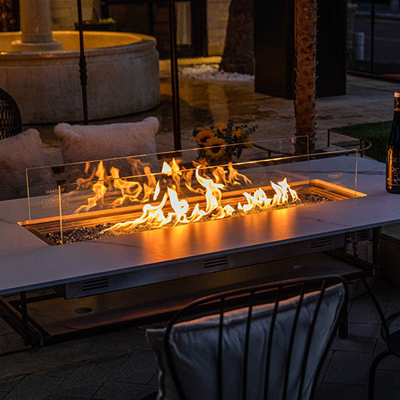 different angle shot of the Oslo Marble Porcelain Dining Table by Elementi Plus in white placed outdoors